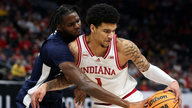  Penn State Nittany Lions forward Qudus Wahab (22) strips the ball from Penn State Nittany Lions guard Ace Baldwin Jr. (1) during the first half at Target Center.